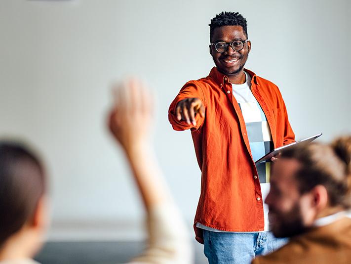 Black university teacher calling on a student in class