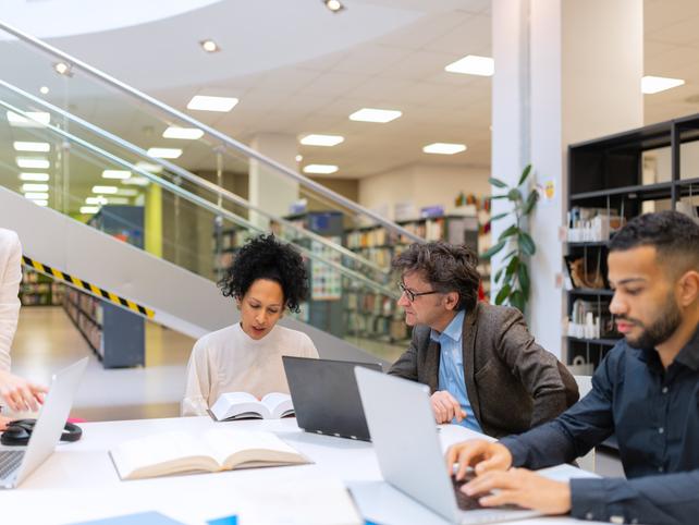 Research staff in a library working on a digital huimanities project