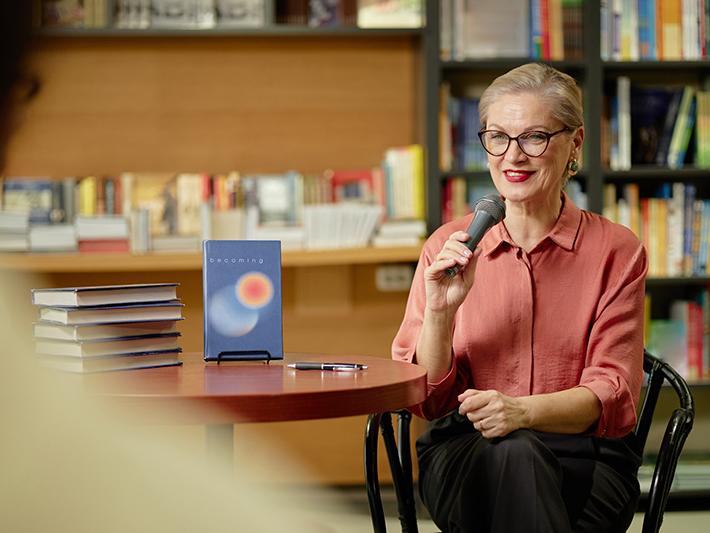 Female author doing a reading in a bookshop