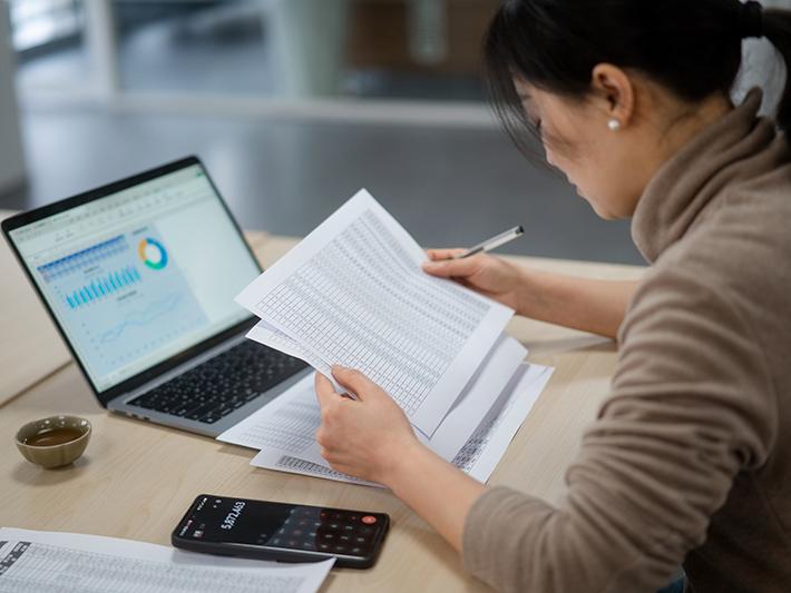 Asian female financial student doing calculations