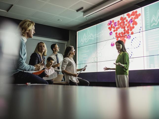 A scientist presenting research to an audience