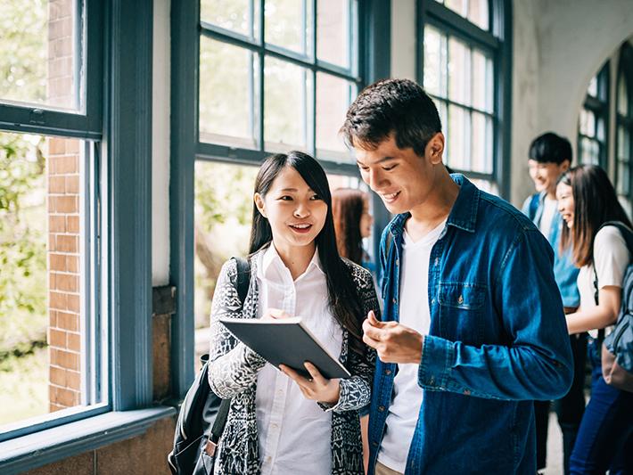 Asian students in light-filled university building