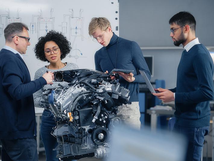 Four engineers considering an automotive problem