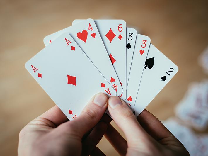 Woman's hands holding playing cards