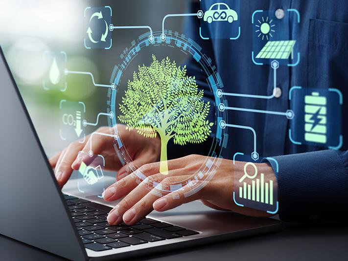 Man typing at laptop with sustainability symbols surrounding it