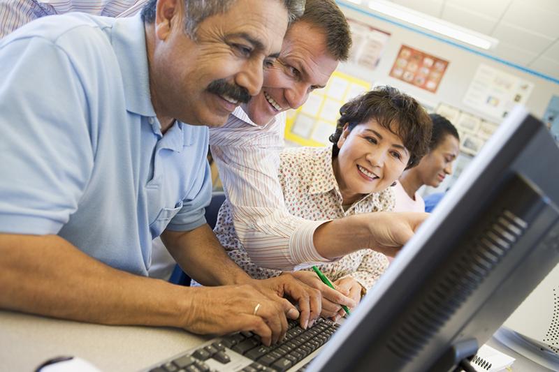 Group of multiracial mature computing students