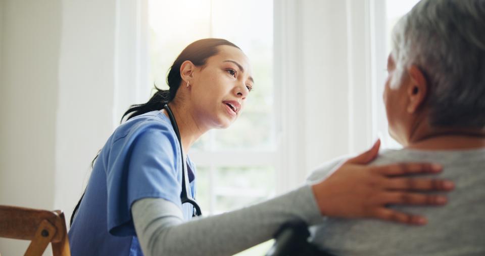 Medical professional talking to a female patient