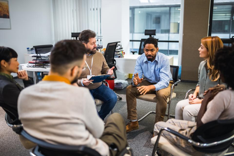 Participants of a focus group chatting in a circle