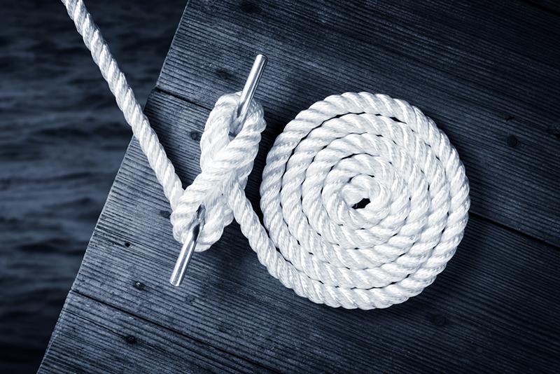 Rope tying boat to dock