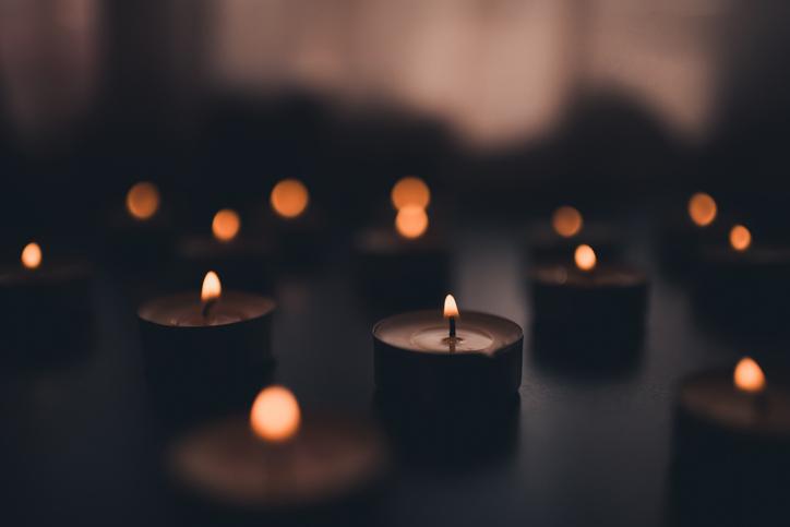 Lit candles in a darkened room