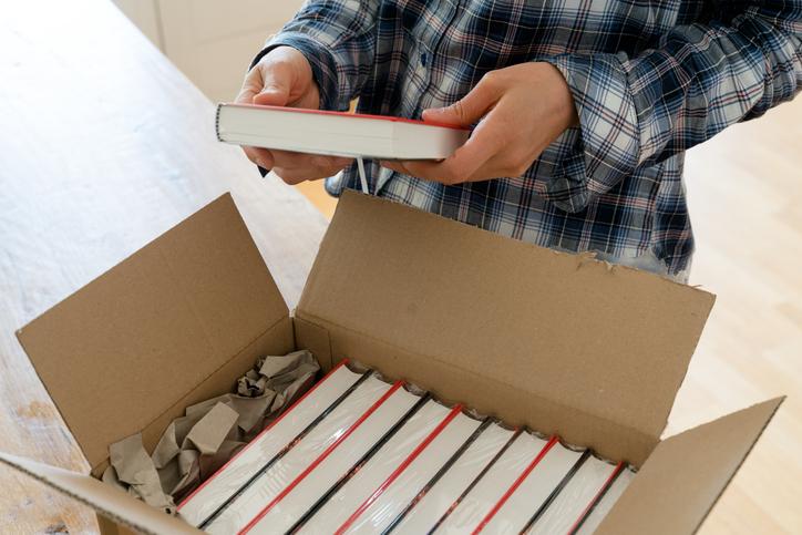 An author looks at a delivery of books