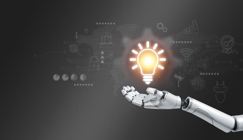 A robot hand holds out a glowing lightbulb