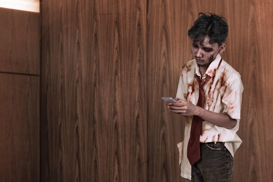 A student zombie scrolling social media on his mobile phone