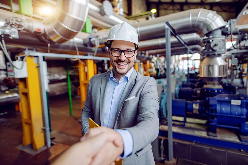 Man in hard hat shaking hands