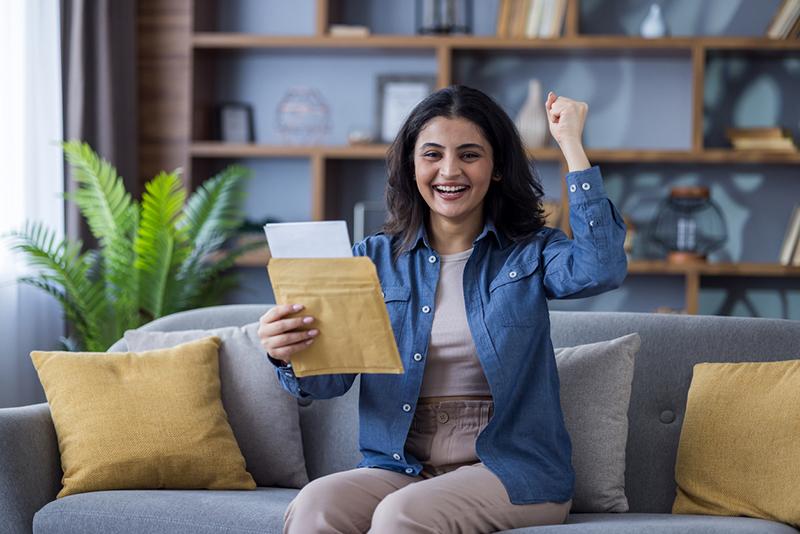 Young happy Indian woman on a couch