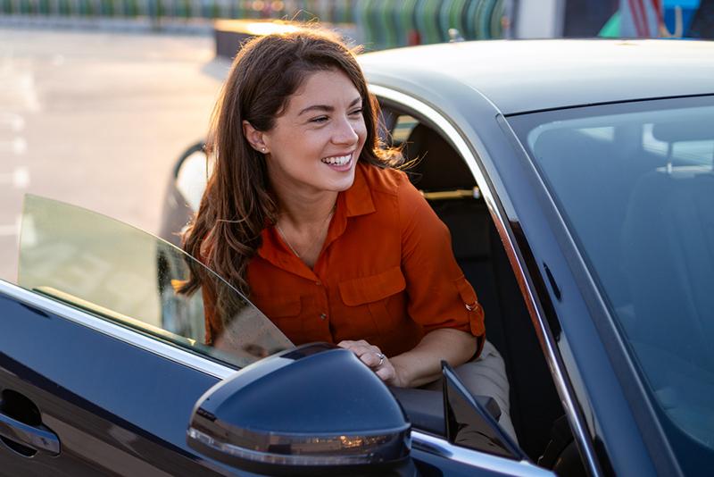 Woman getting out of car