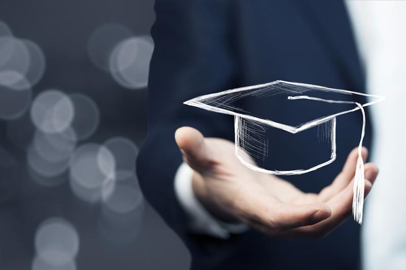 Hand holding mortar board, digital credentials