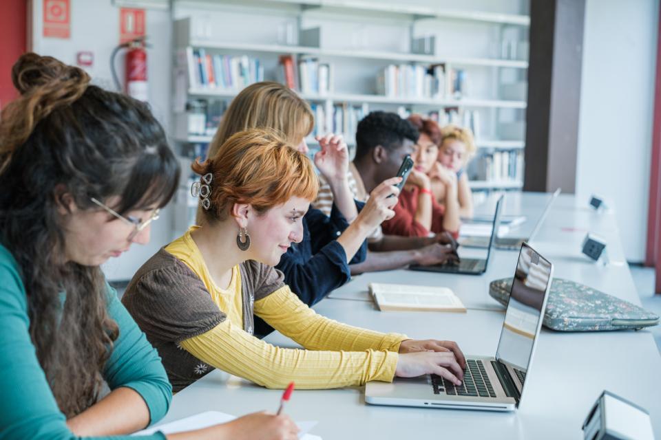 Students on laptops in a classroom