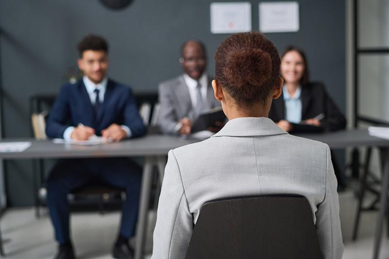 Young black woman before panel during job interview