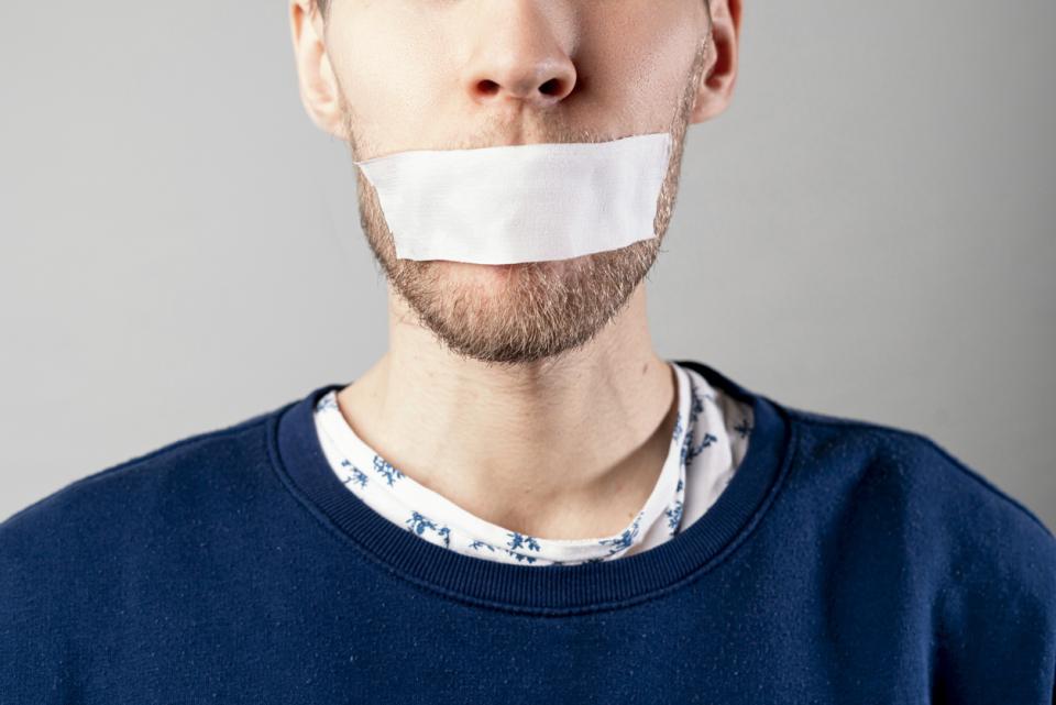 A man with tape on his mouth