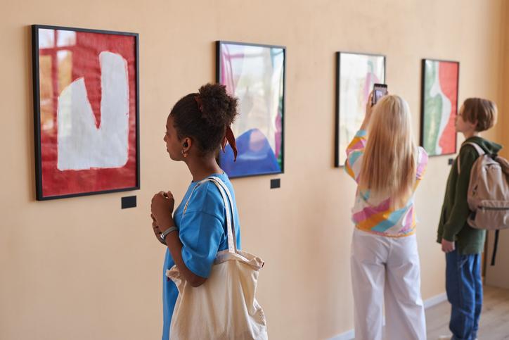 Students observe art in a gallery