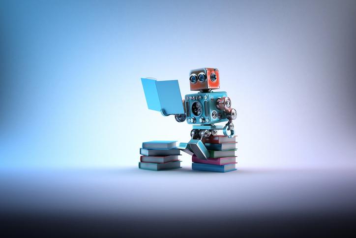 A toy robot sits on a stack of books