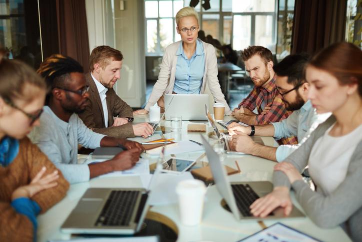 A meeting takes place around a long table