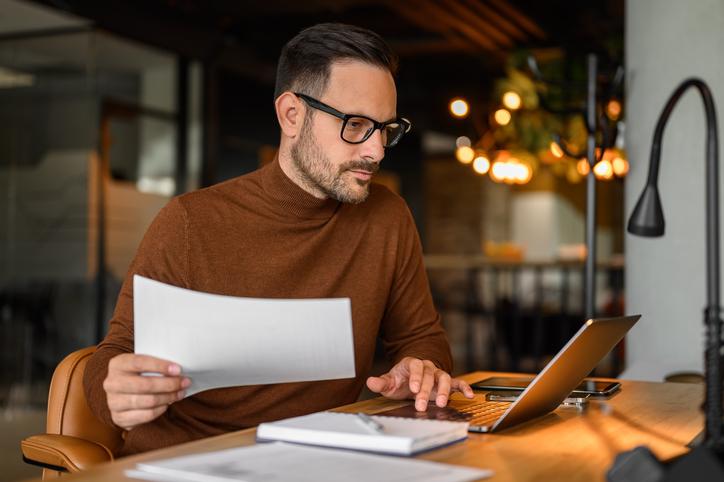 A researcher works at a laptop
