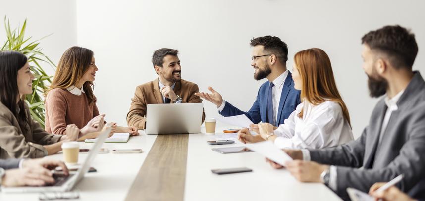 A meeting takes place around a long table