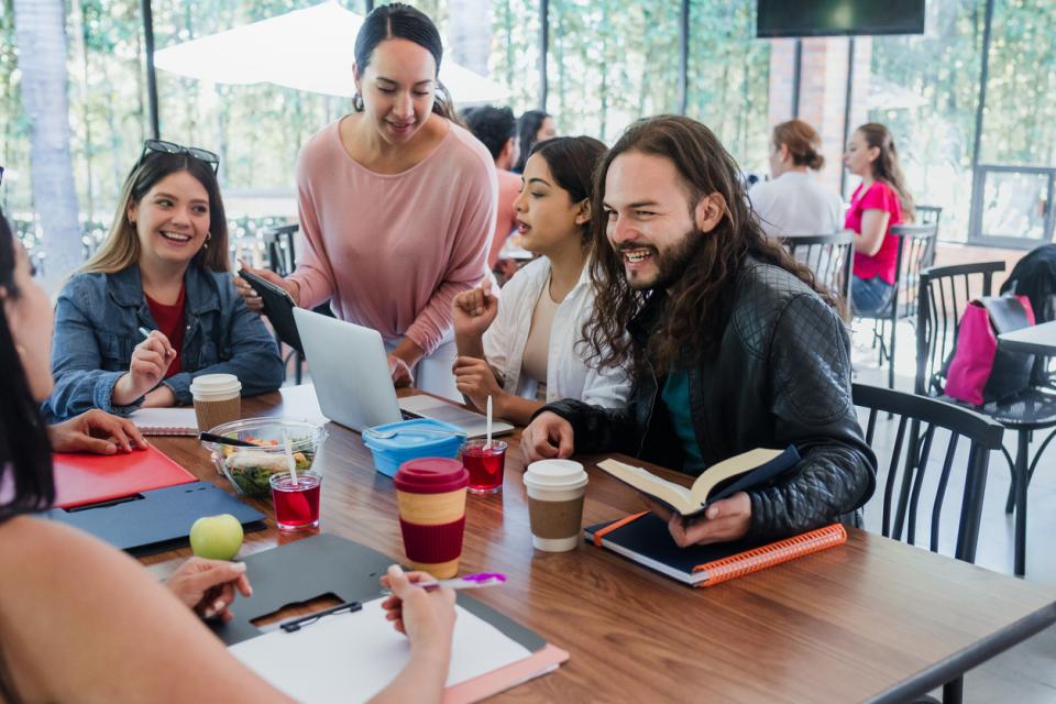 Students chatting together at a table in class