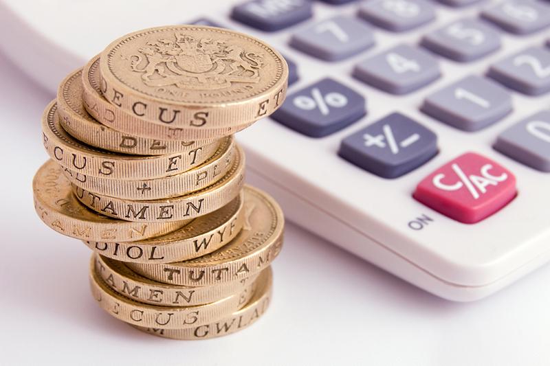 UK pound coins and a calculator