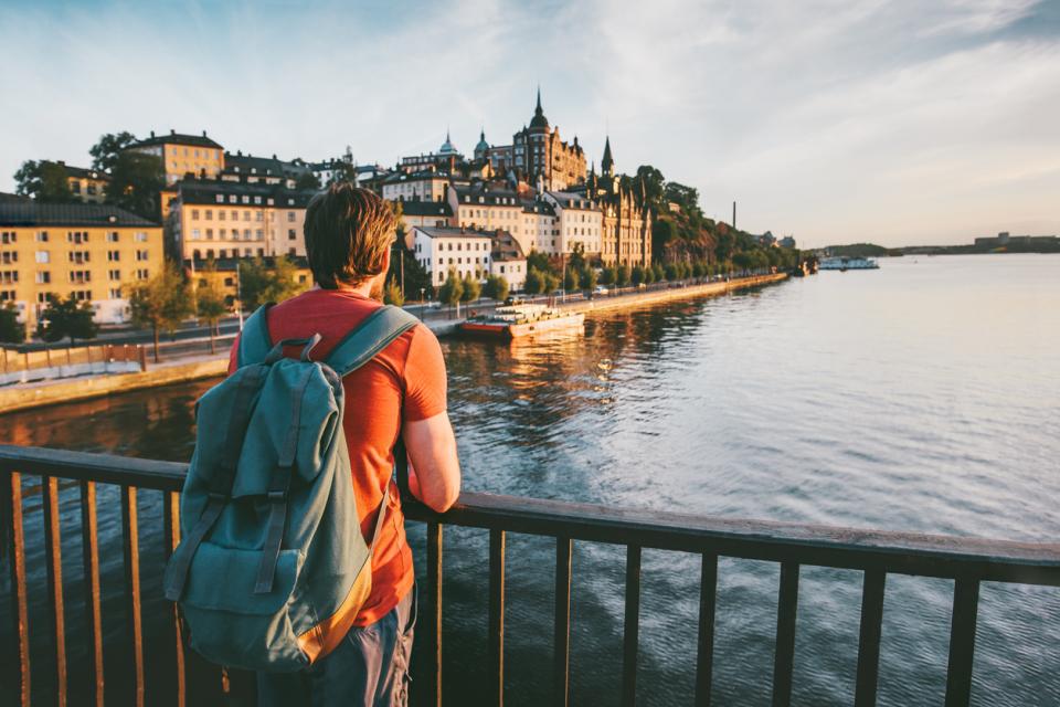 A young man admiring a view from a bridge in Stockholm