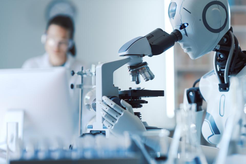 A robot uses a microscope in a laboratory