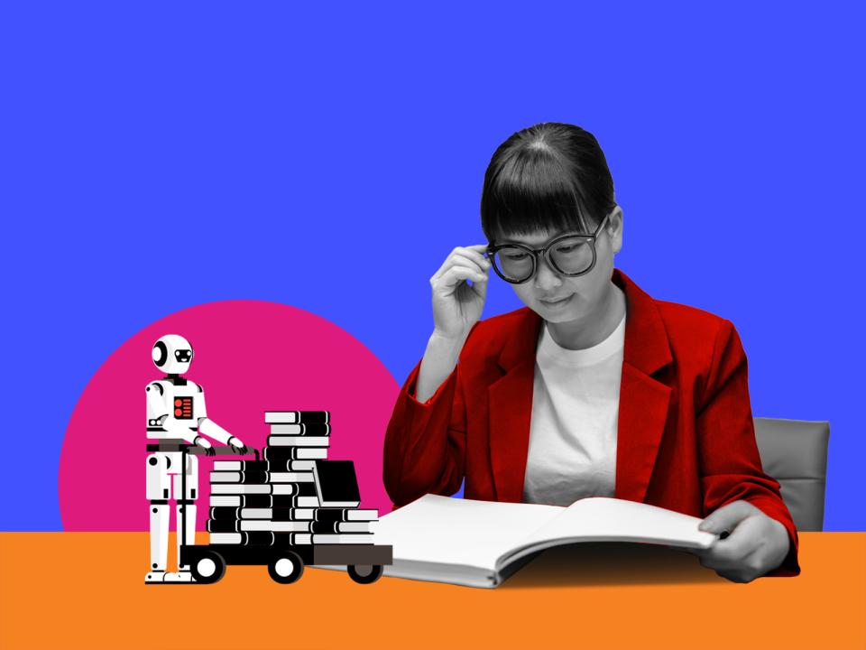 A researcher reading a pile of books next to a robot with a trolley of more books