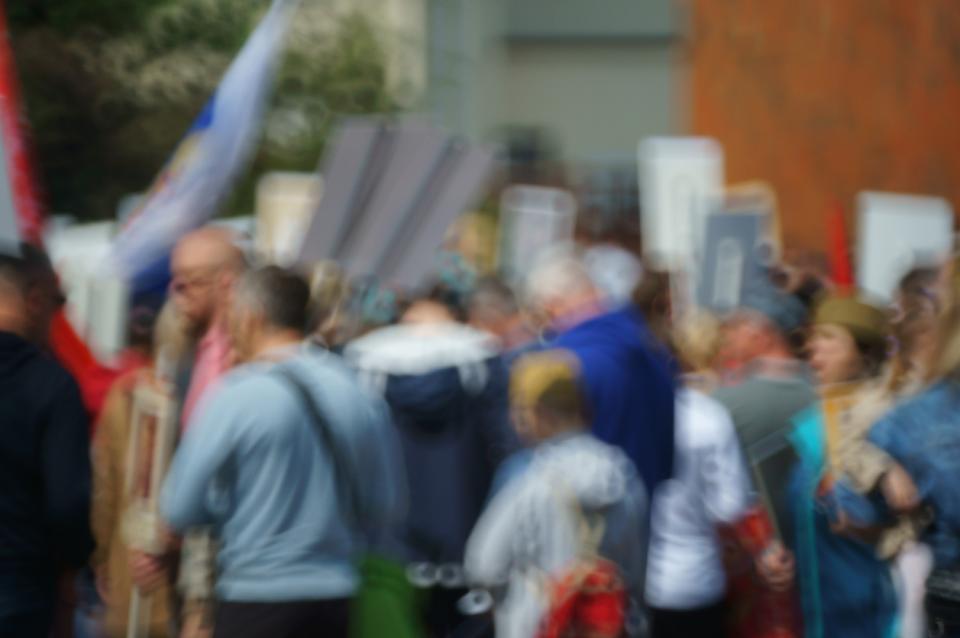 Blurred protestors carrying signs