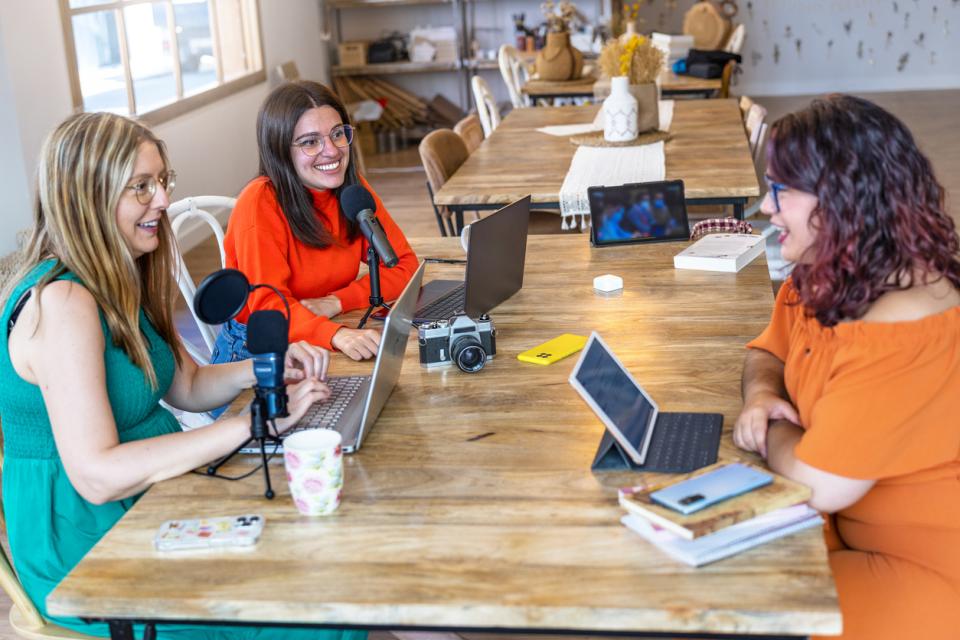 Students sitting at a table with their laptops