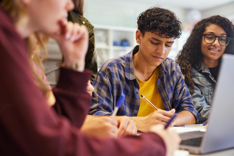 Students working at their laptops in a university classroom