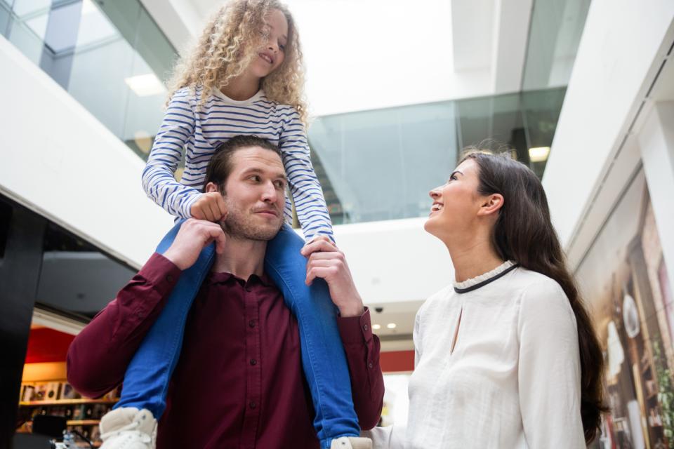 A young family walking through a university building
