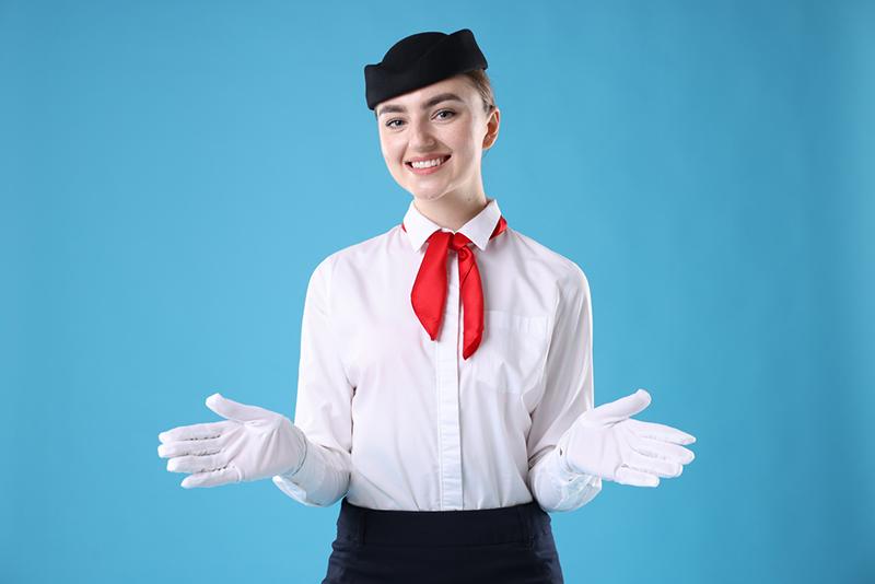 Flight attendant demonstrating safety procedures against blue background