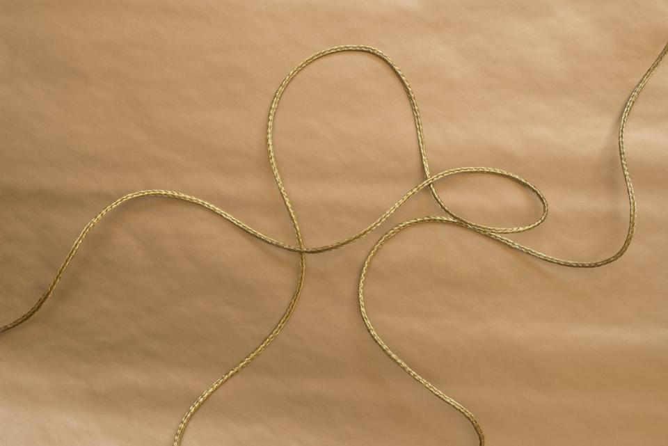 A golden thread against a brown background