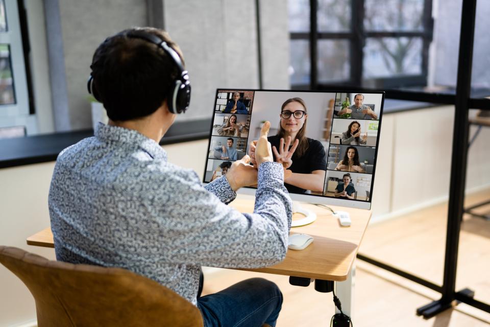 A deaf student on a video call with other participants using sign language