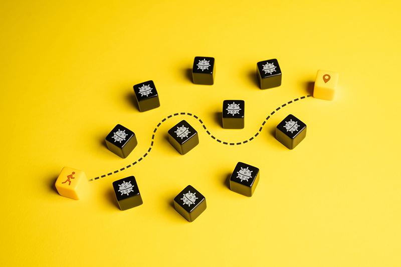 Blocks showing man making path between bombs to idea