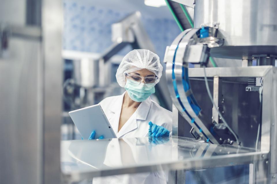 A pharmaceutical machine inspector at work in science laboratory