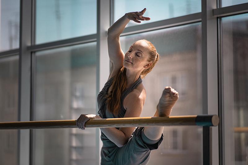 ballet dancer stretching at barre
