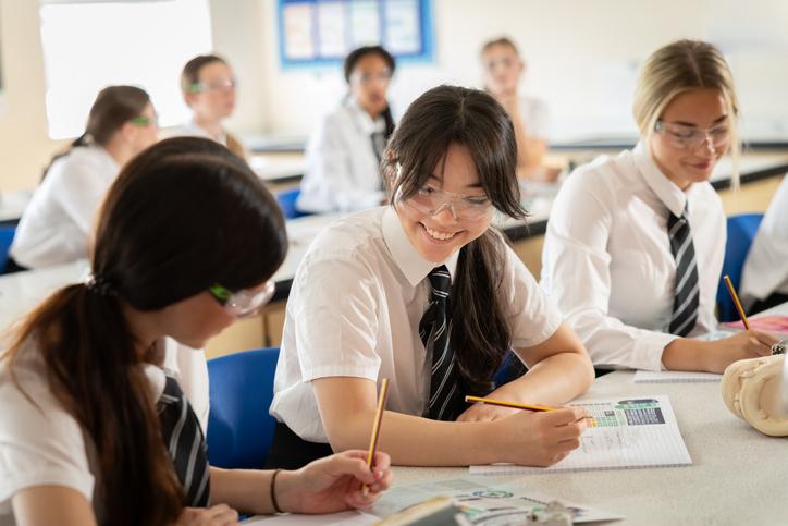Secondary school pupils studying science in a classroom 