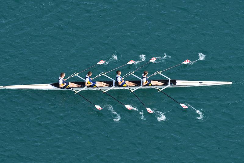 Male rowing team on water