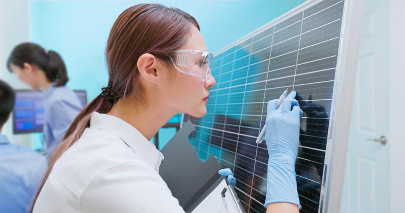 A researcher inspects solar panels in a lab