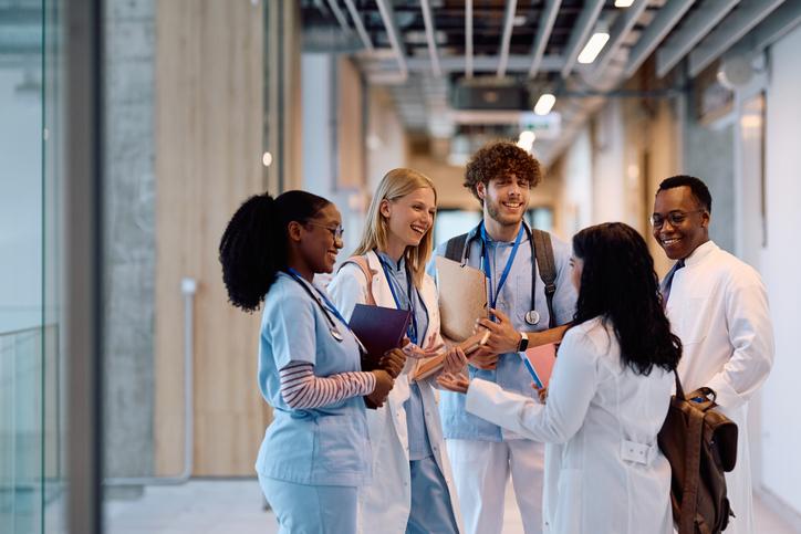 Medical students talk in a university corridor