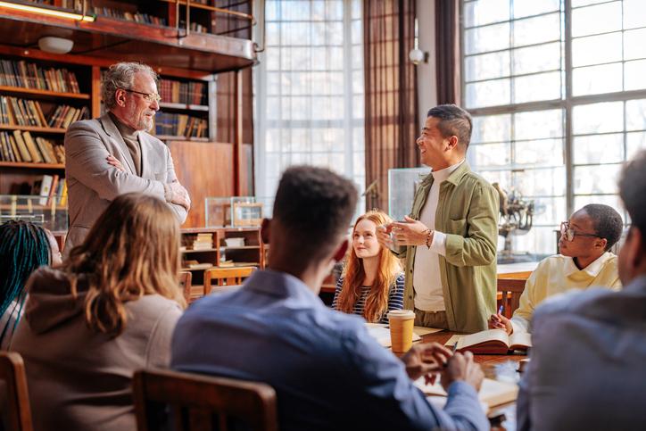 Academics sharing ideas in a university library