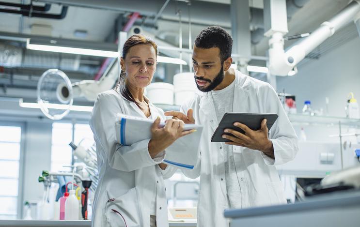 Scientists discuss results in a lab